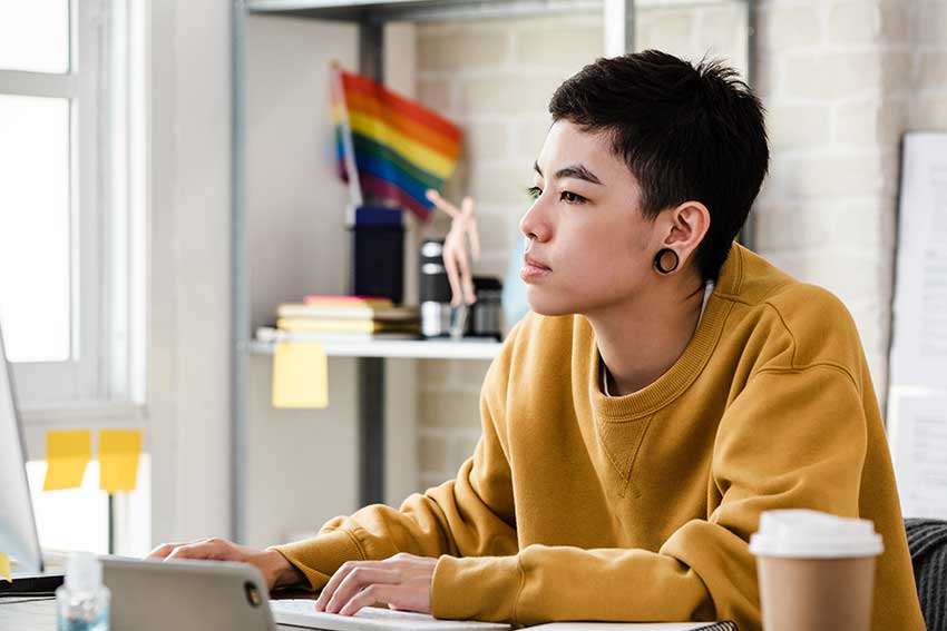 Young person in casual attire working from home in living room