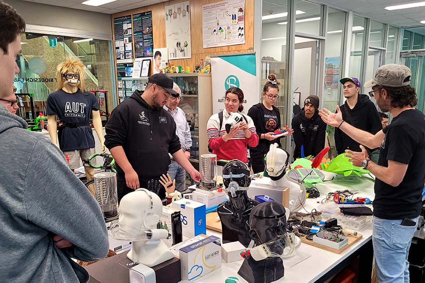 Participants around a table of equipment