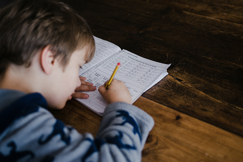 Stock image of a young primary school student doing a test.