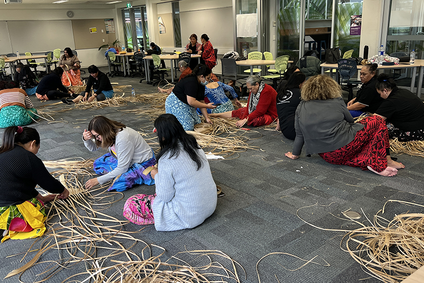 A group of early childhood education teachers sitting on the floor learning weaving Samoan mats.