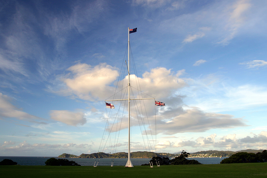 The flagpole at Waitangi, flying three flags on a nice day.