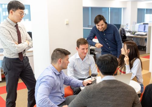 Group of young workers discussing a project