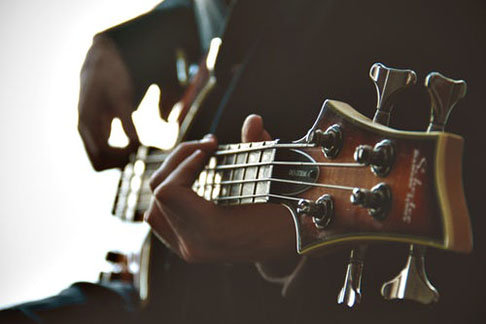 Fingers of person playing a guitar